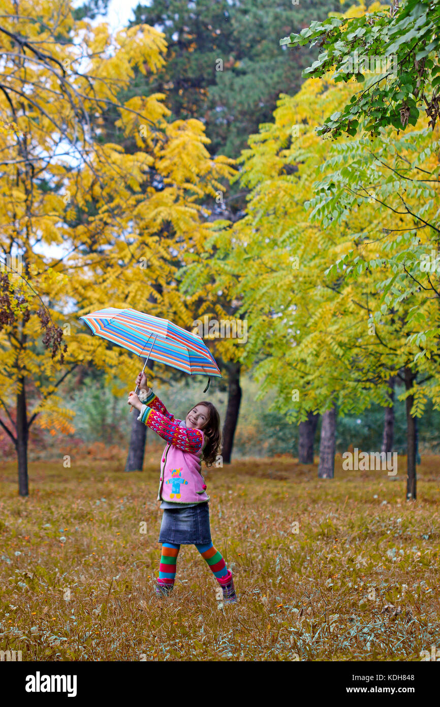 happy little girl in autmn park Stock Photo - Alamy