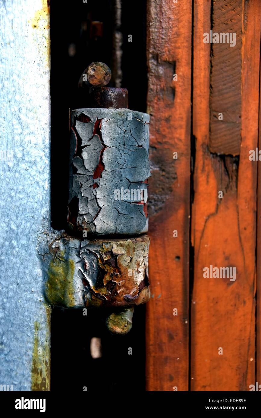 old and rusty door hinge, closeup of rusty door hinge with peeled