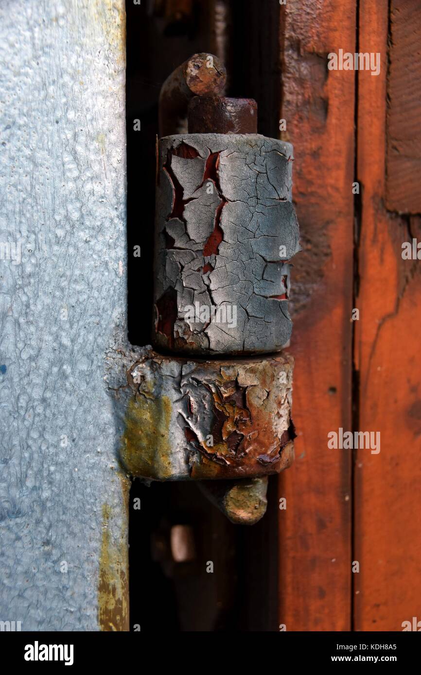 old and rusty door hinge, closeup of rusty door hinge with peeled