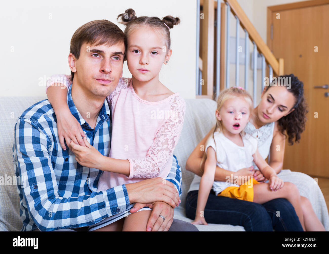 Portrait of sad family of four discussing separation in home Stock Photo -  Alamy