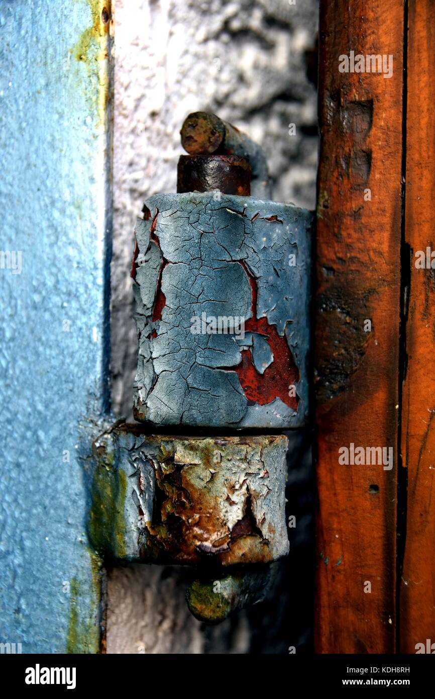old and rusty door hinge, closeup of rusty door hinge with peeled