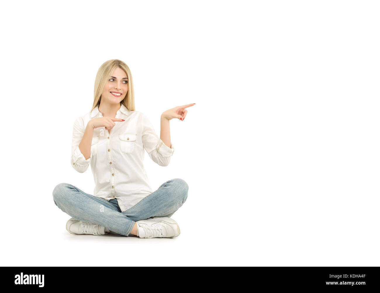 Woman sitting on the floor and pointing with her finger Stock Photo - Alamy