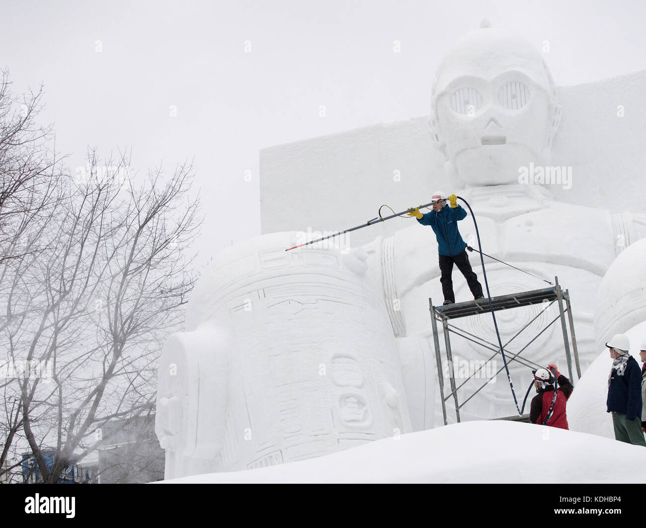 Maintenance crew preparing the Star Wars snow sculpture exhibition for the Sapporo Snow Festival, Hokkaido, Japan Stock Photo