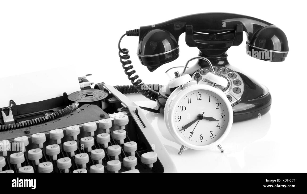 Old office Still life with retro typewriter, alarm clock, telephone on a white background with copy space Stock Photo