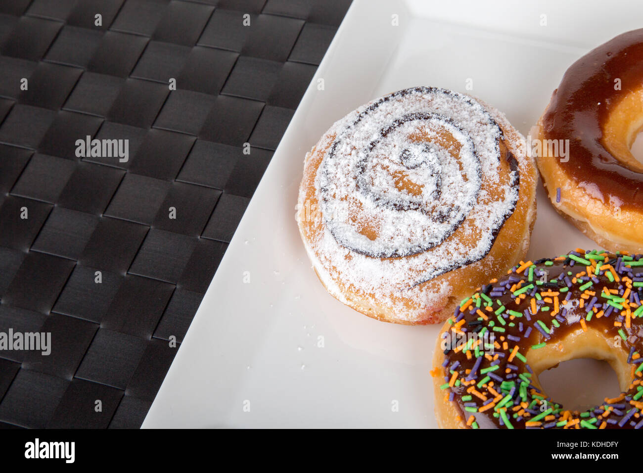 Close up detailed view of yummy donuts with chocolate, powdered sugar ...
