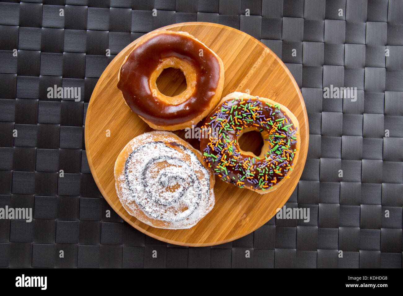 Top view of yummy donuts with chocolate, powdered sugar and sweets on ...