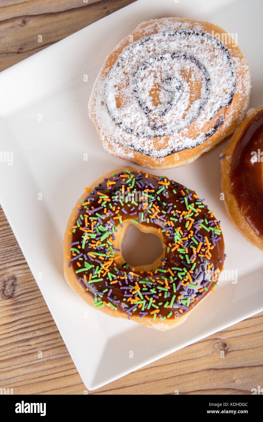 Close up detailed view of yummy donuts with chocolate, powdered sugar ...