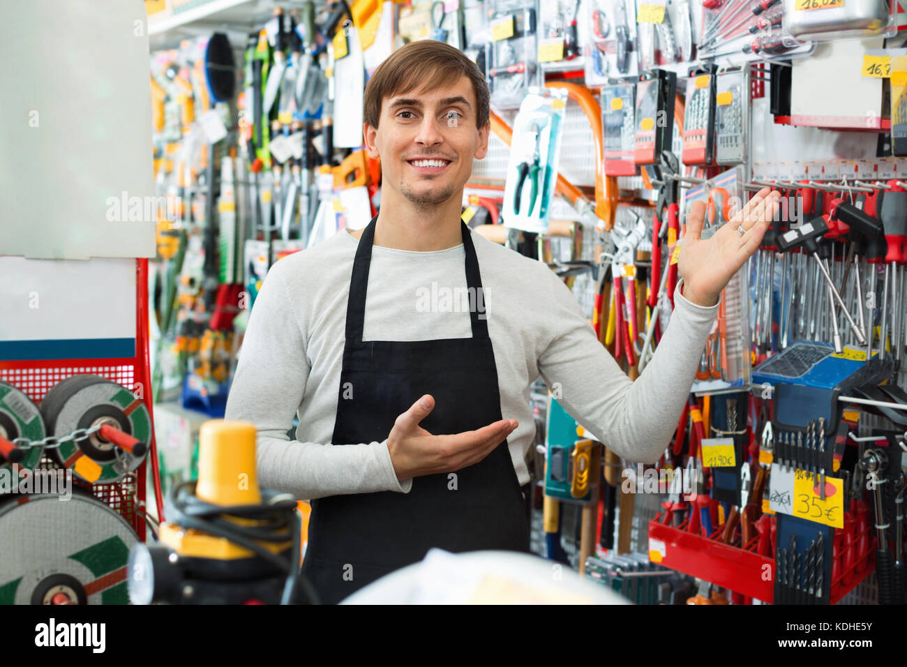 Professional young positive salesman working and smiling in building ...