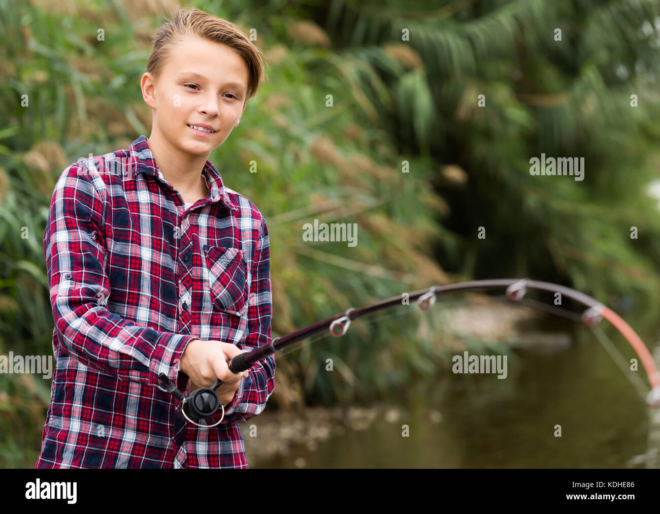 Kid holding fishing pole hi-res stock photography and images