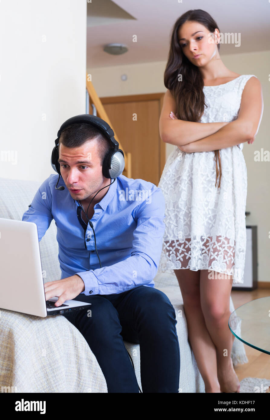 Sad young woman suspecting spouse spending money on games online Stock Photo