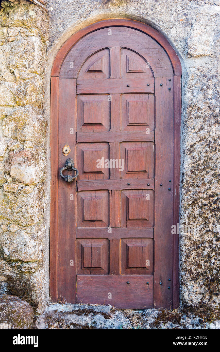 Old wooden door stone wall. Brown door Stock Photo - Alamy