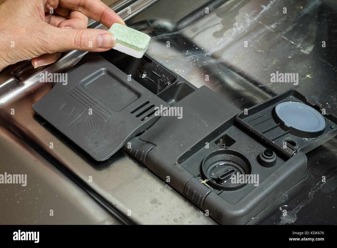Dishwasher with dirty dishes. Powder, dishwashing tablet and rinse aid
