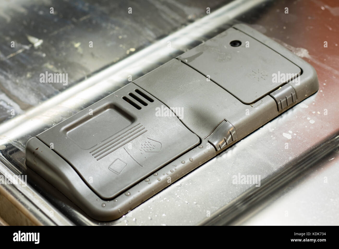 Dishwasher with dirty dishes. Powder, dishwashing tablet and rinse aid