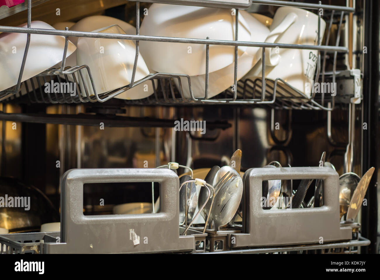 Dishwasher with dirty dishes. Powder, dishwashing tablet and rinse aid