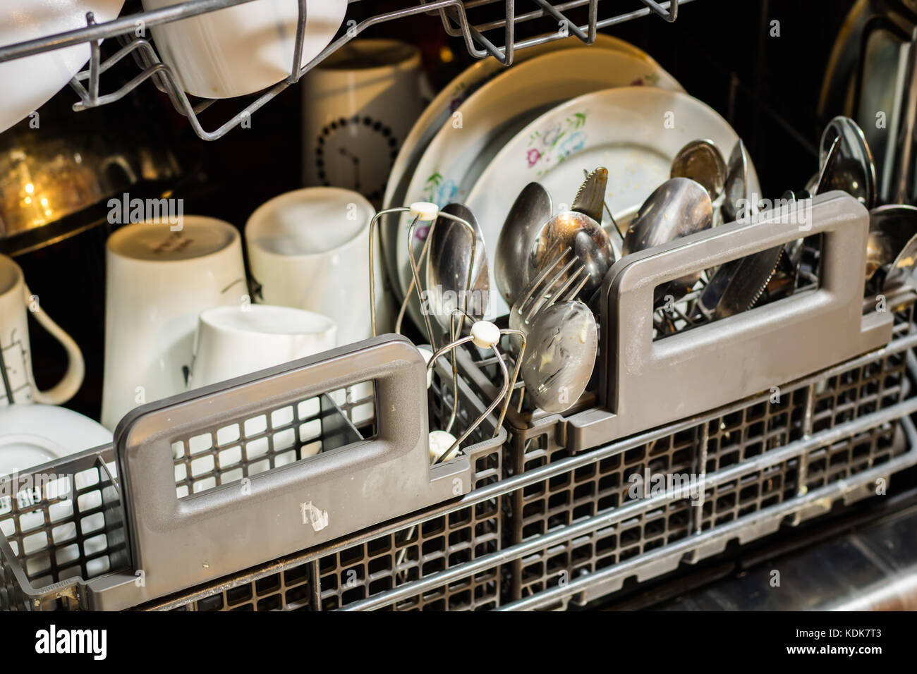 Dishwasher with dirty dishes. Powder, dishwashing tablet and rinse aid