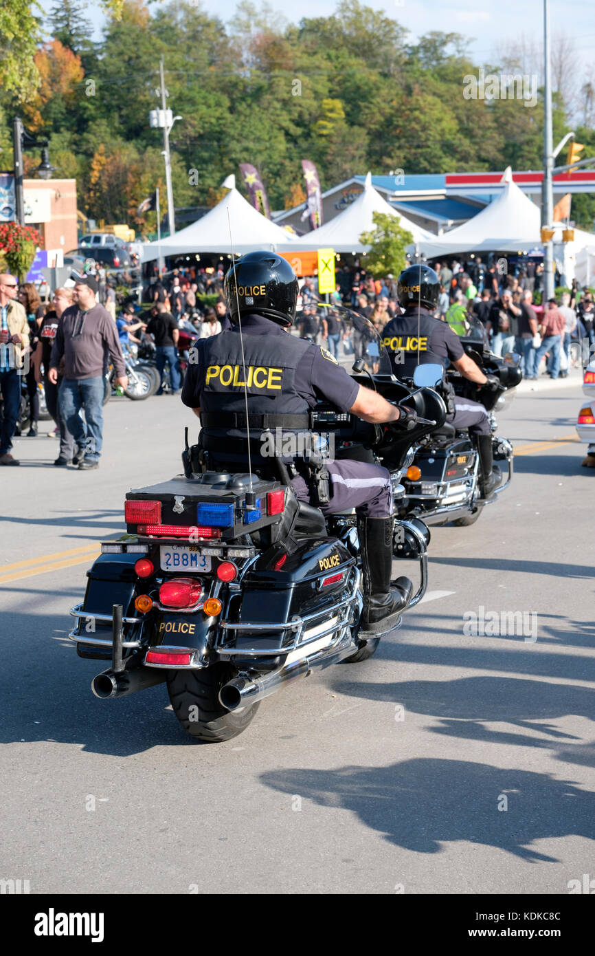 Port Dover, Ontario, Canada, 13th October 2017. Thousands of motorcyclists from all over Canada and the USA get together for The Friday 13th Motorcycle Rally, held every Friday the 13th in Port Dover, Ontario, Canada, since 1981. The event is one of the largest single-day motorcycle events in the world. This year, the mild weather contributed for a large number of bikers and onlookers, with hundreds of custom motorcycles, vendors, live music and interesting people to watch. Ontario Provincial Police (OPP) officers on motorcycles patrolling Main Street. Credit: Rubens Alarcon/Alamy Live News Stock Photo