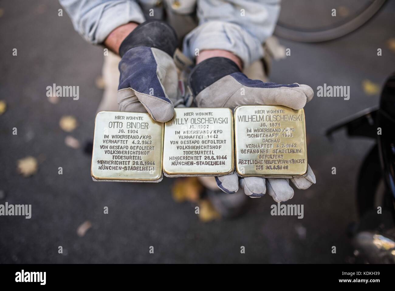 Munich, Bavaria, Germany. 14th Oct, 2017. Artist Gunter Demnig. Despite lengthy battles, the so-called Stolpersteine ('Stumbling Blocks'') containing the names & information of victims of National Socialism were installed at four different sites in Munich. The City of Munich forbid the installation of the memorial stones on public ground in 2015, which led the Stolpersteine Initiative (''˜Stumbling Block Initiative'') to seek private properties to install them. To date, 61,000 Stolpersteine in 2,000 cities in 21 countries have been dedicated, with much criticism lobbed against Munich Stock Photo