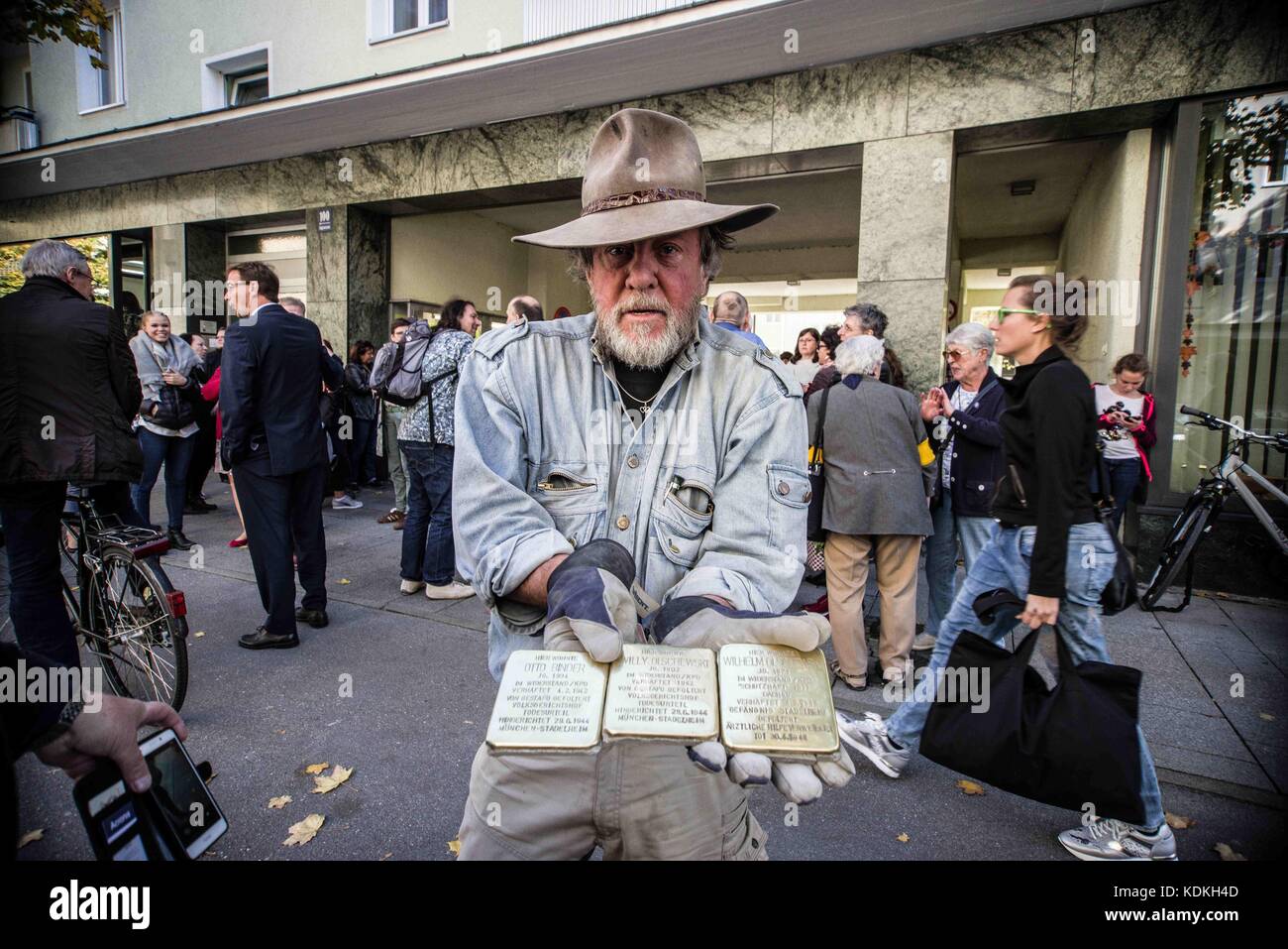 Munich, Bavaria, Germany. 14th Oct, 2017. Artist Gunter Demnig. Despite lengthy battles, the so-called Stolpersteine (Ã¢â‚¬Å“Stumbling BlocksÃ¢â‚¬Â) containing the names & information of victims of National Socialism were installed at four different sites in Munich. The City of Munich forbid the installation of the memorial stones on public ground in 2015, which led the Stolpersteine Initiative (Ã¢â‚¬ËœStumbling Block InitiativeÃ¢â‚¬Â) to seek private properties to install them. To date, 61,000 Stolpersteine in 2,000 cities in 21 countries have been dedicated, with much criticism lobbe Stock Photo