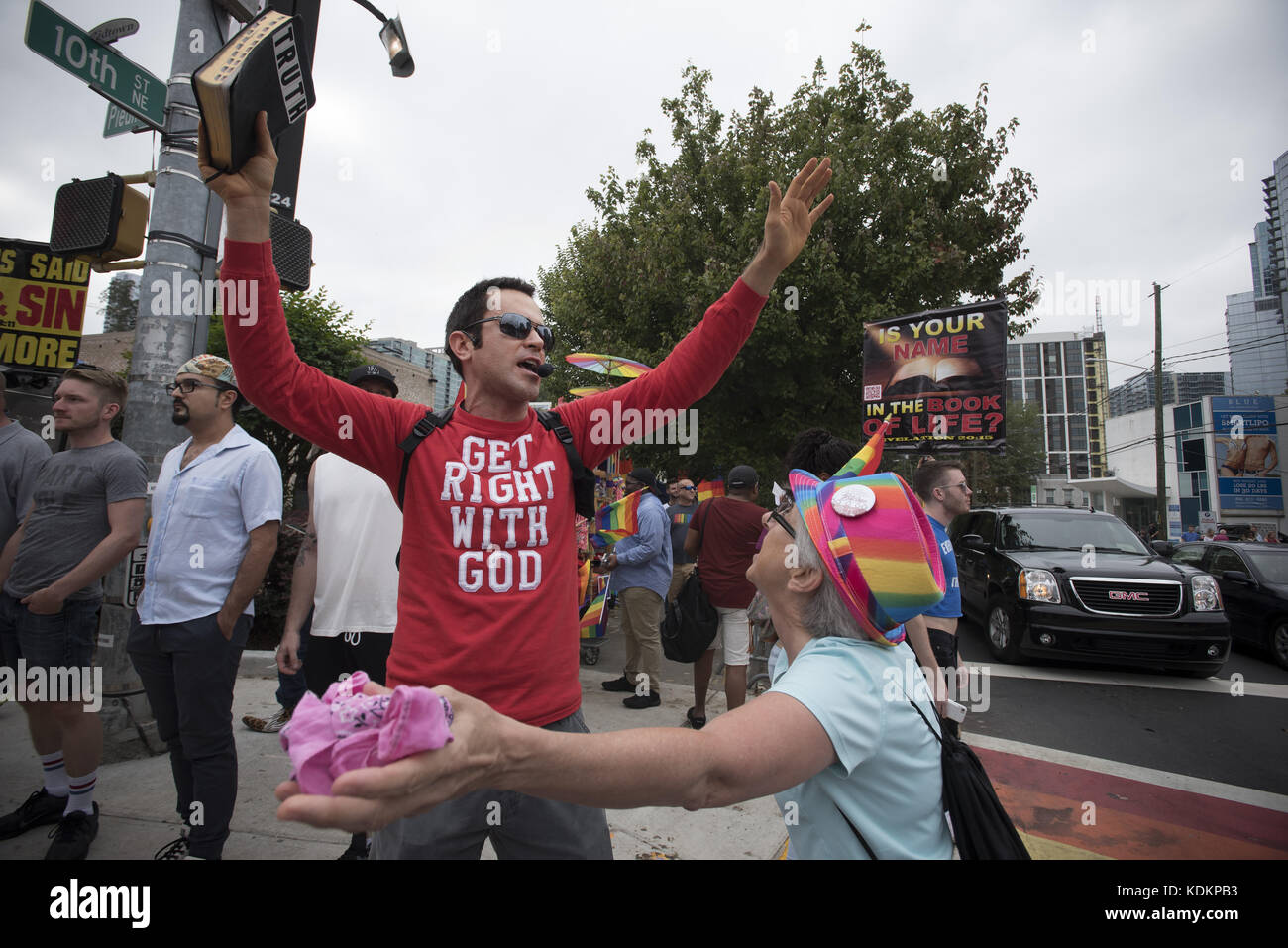 Atanta, GA, USA. 14th Oct, 2017. A street evangelist preaches from street corner in center of Atlanta's midtown, 'ground zero' for the city's LGBTQ community. A senior citizen who is a strong gay and transgender rights advocate tried to initiate a conversation with the preacher but was unsuccessful. Credit: Robin Rayne Nelson/ZUMA Wire/Alamy Live News Stock Photo