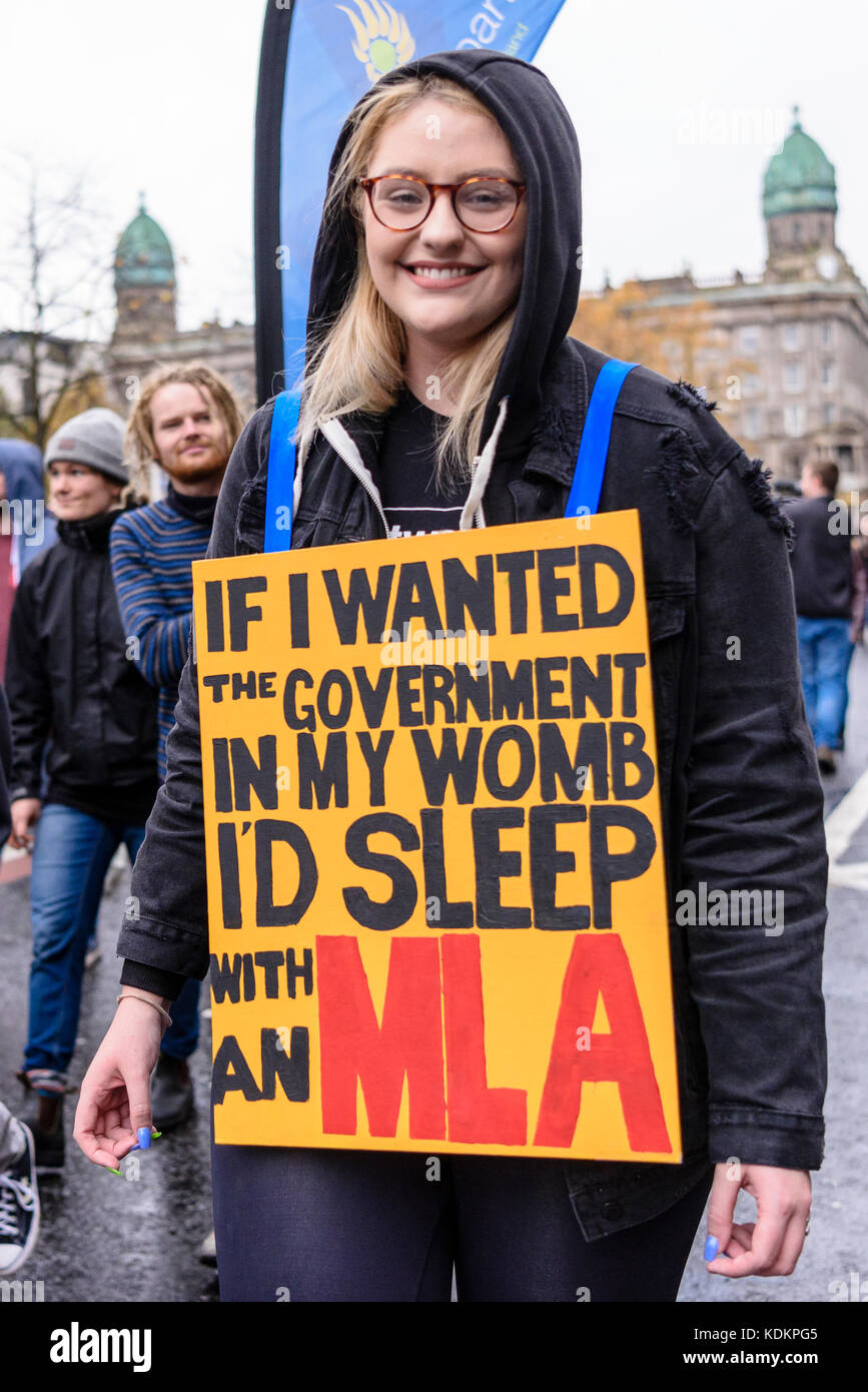 Belfast, Northern Ireland. 14/10/2017 - A woman wears a sign saying 'If I wanted the government in my womb I'd sleep with an MLA' durina a Rally For Choice parade in support of pro-choice abortion rights and women's reproductive rights.  Approximately 1200 people attended the event. Stock Photo