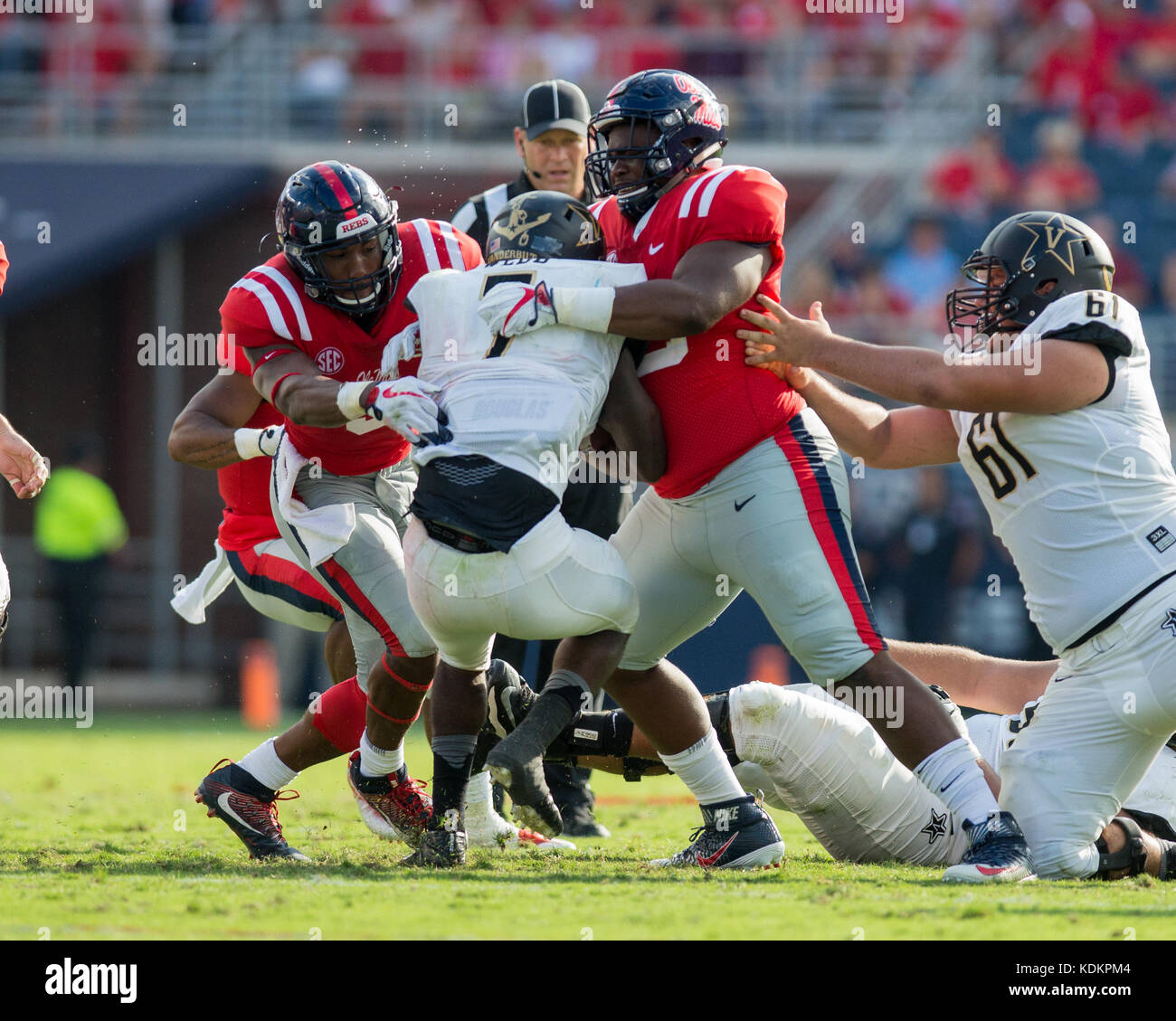 Oxford, USA.  14th October 2017. University of Mississippi Linebacker DeMarquis Gates (3) and Defensive Tackle Ross Donelly (90) stop and bring down Vanderbilt Running Back Ralph Webb (7) at Vaught-Hemingway Stadium in Oxford, Mississippi, on Saturday, October 14, 2107.  Credit: Kevin Williams/Alamy Live News. Stock Photo