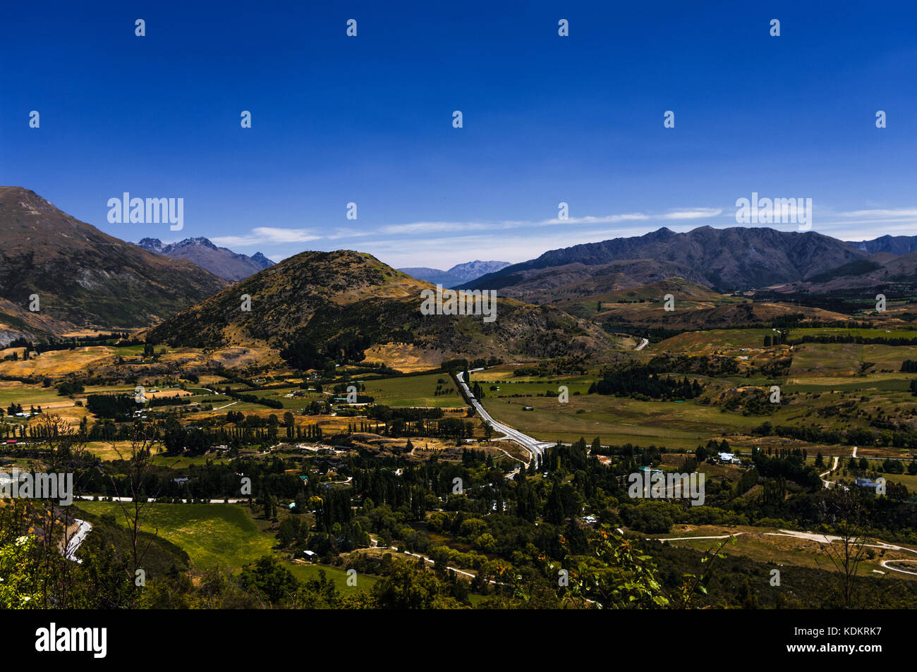 Arrow Junction, Otago • New Zealand   Arrow Junction from Crown Range with the Remarkables in the distance Stock Photo