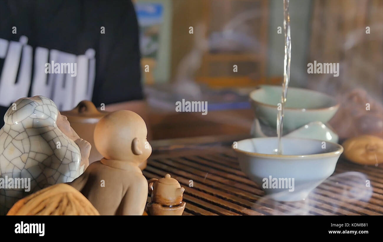Traditional Chinese Tea Ceremony and pour the tea in a glass of the ...
