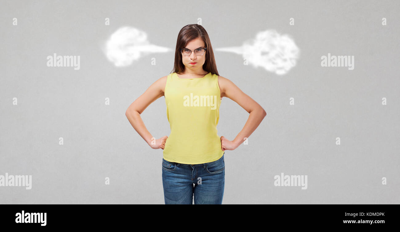 Dissatisfied wicked girl on a gray background.  Stock Photo