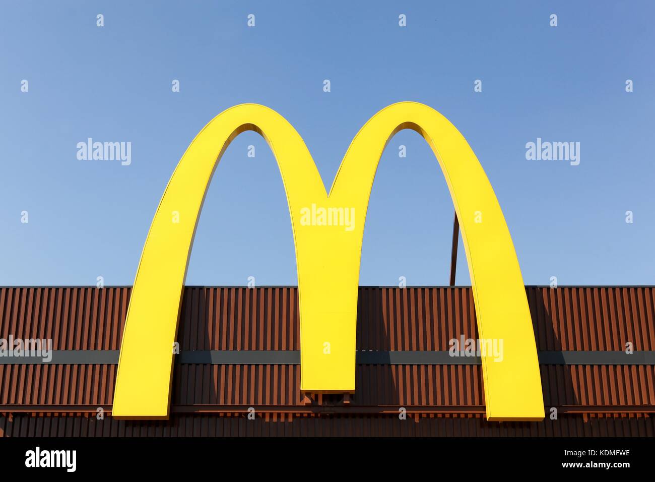 Milano, Italy - July 21, 2015: McDonald's logo on a facade. McDonald's is the world's largest chain of hamburger fast food restaurants Stock Photo