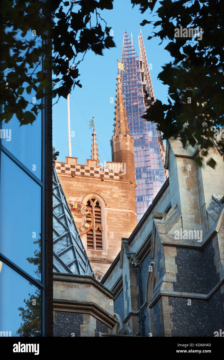 London - The top of Shard tower and tower of Southwark cathedral in evening light. Stock Photo
