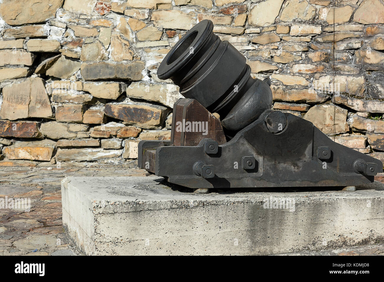 cannon mortar near the stone wall in the fortress Stock Photo