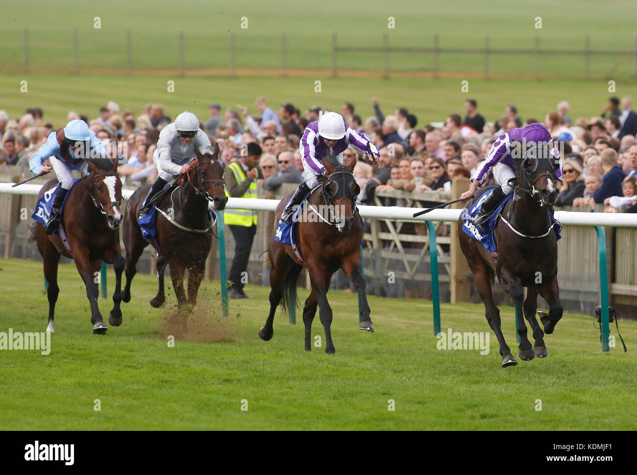 U S Navy Flag ridden by Ryan Moore leads the field home to win The Darley Dewhurst Stakes Race run during day two of the Dubai Future Champions Festival at Newmarket Racecourse, Newmarket. Stock Photo