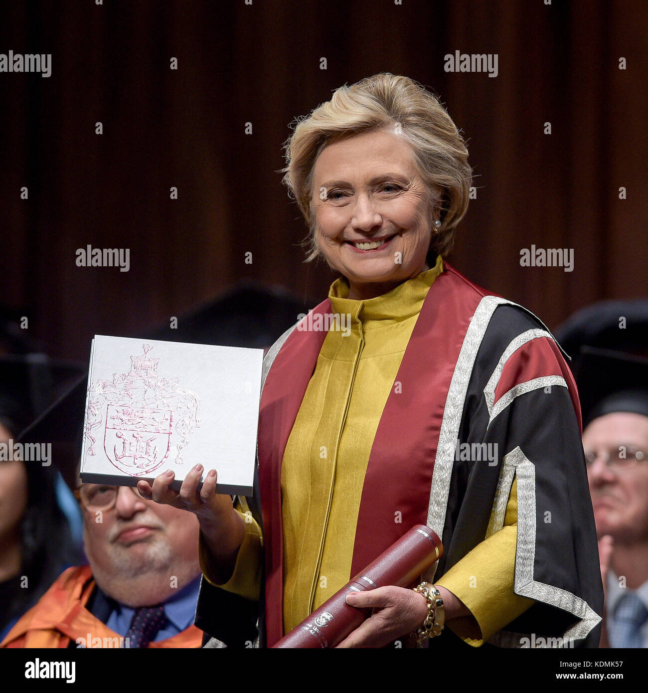 Hillary Clinton receives a Honorary Doctorate and holds up a book of her Welsh family history, at Swansea University, in recognition of her commitment to promoting the rights of families and children around the world, a commitment that is shared by Swansea University's Observatory on the Human Rights of Children and Young People. Stock Photo