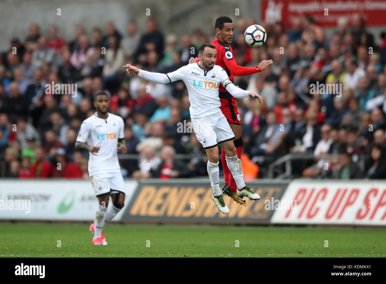 Huddersfield Town's Tom Ince (right) and Swansea City's Leon Britton ...
