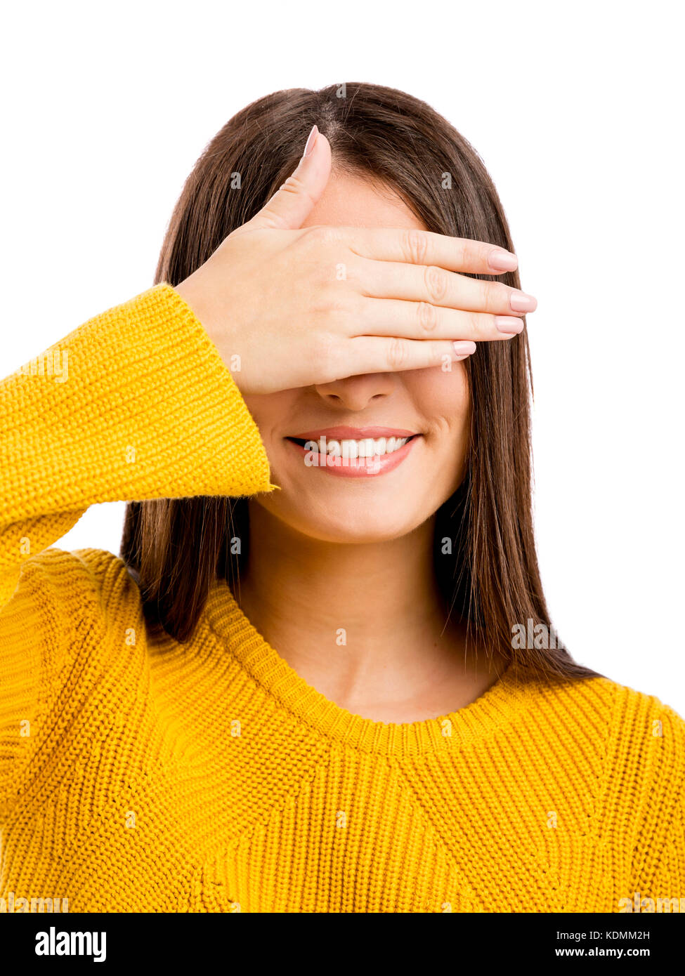 Portrait of a beautiful woman covering her own eyes Stock Photo