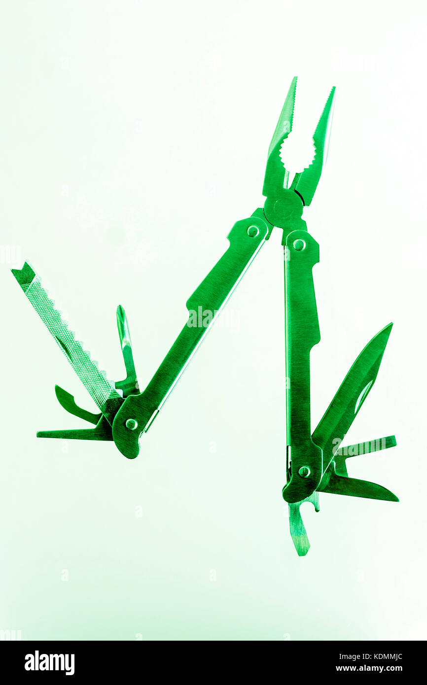 A green pocket multi tool, saw,knife,screwdriver,pliers Stock Photo Alamy