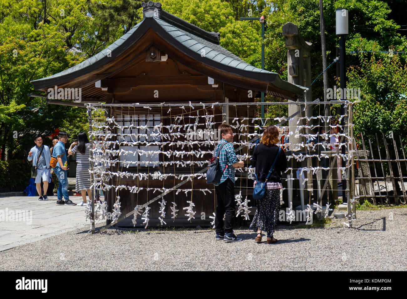 Kyoto, Japan - May 19, 2017: O-mikuji fortune papers tied to a rack at  at the Yasaka jinja shrine in Kyoto Stock Photo