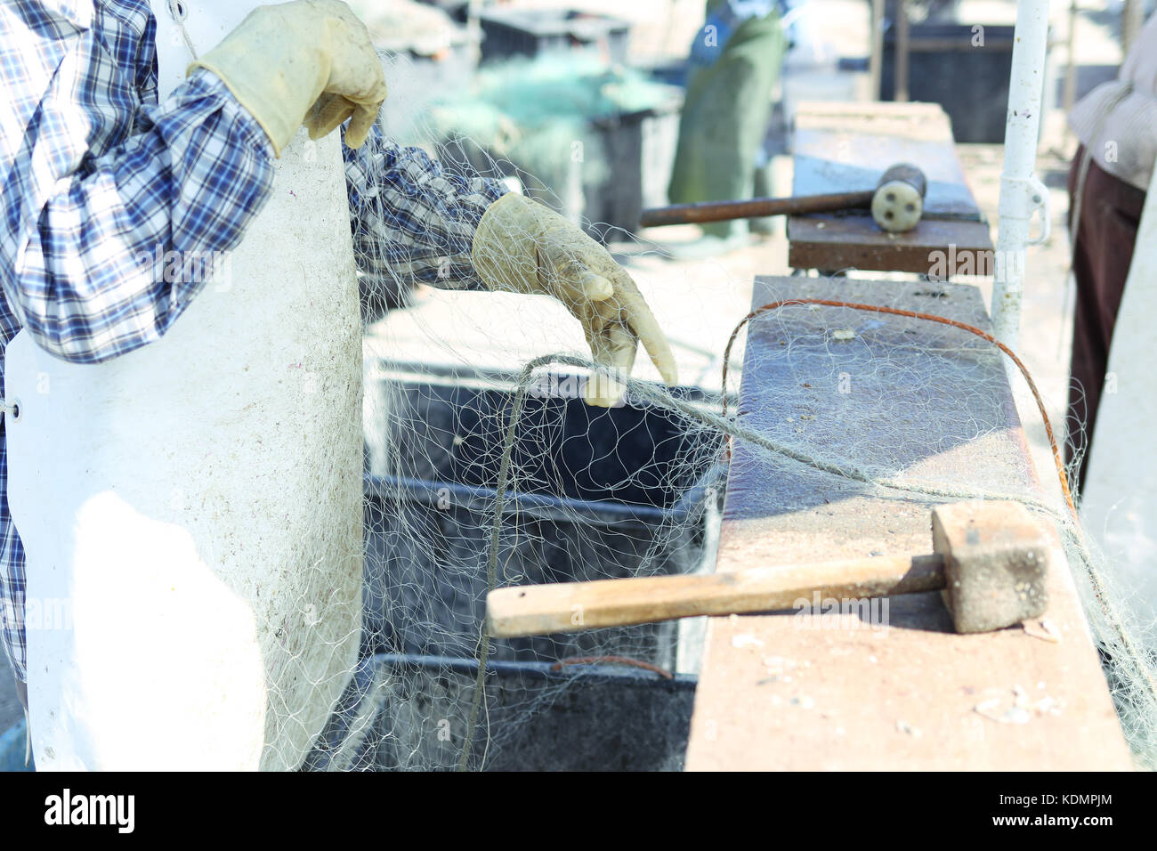 Fisherman cleaning fishing net Stock Photo Alamy