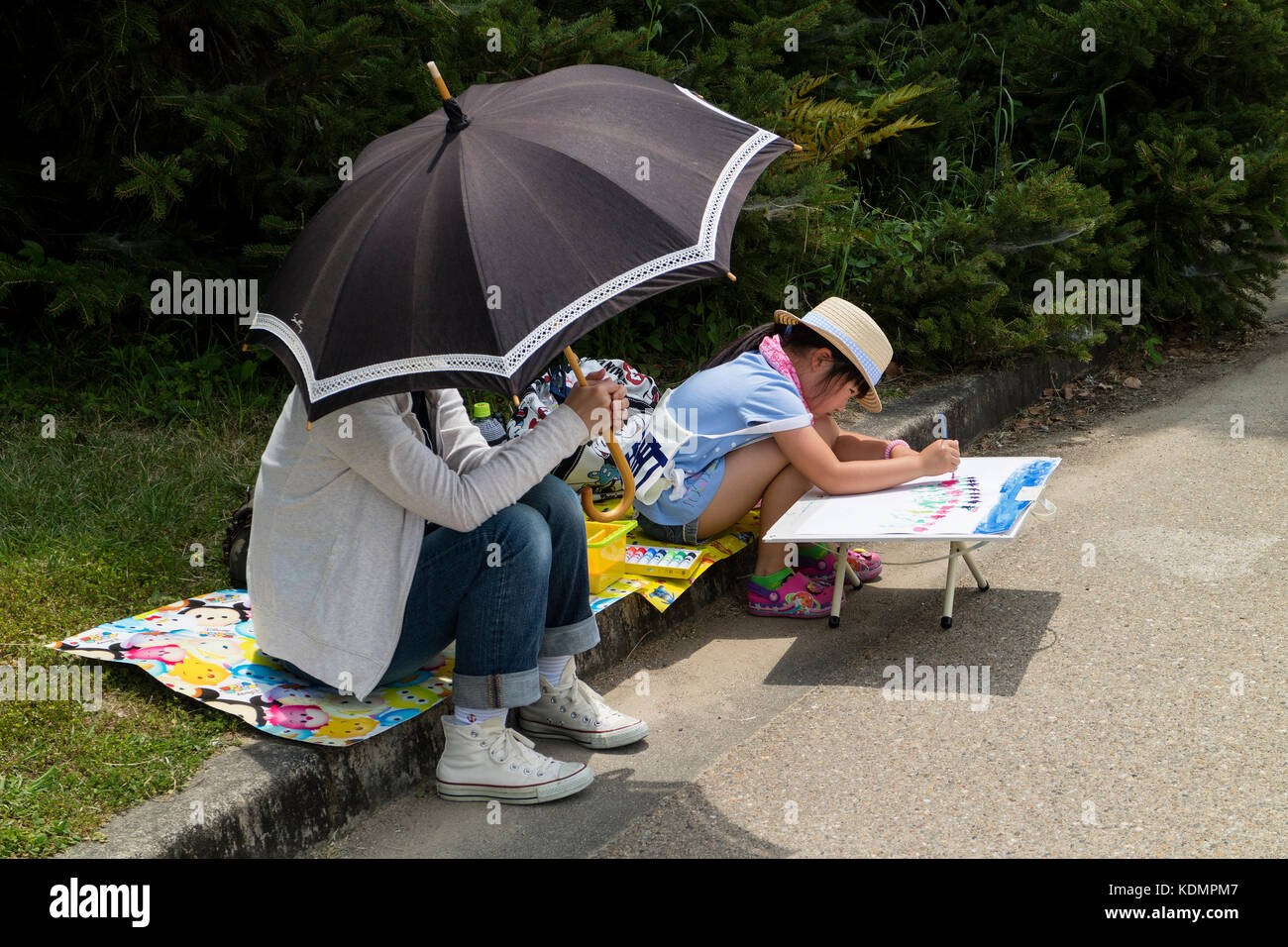 Kyoto, Japan - May 21, 2017: Child is painting in the Kyoto botanical garden to learn the shape of flowers and plants Stock Photo