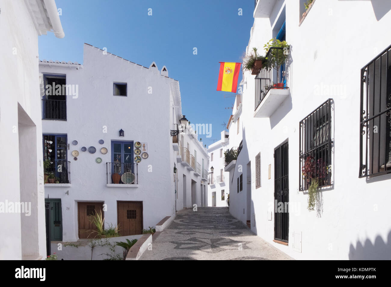 Spanish flag flying in Frigiliana, a popular day trip for visitors to the seaside resorts of the Costa del Sol in southern spain. Stock Photo