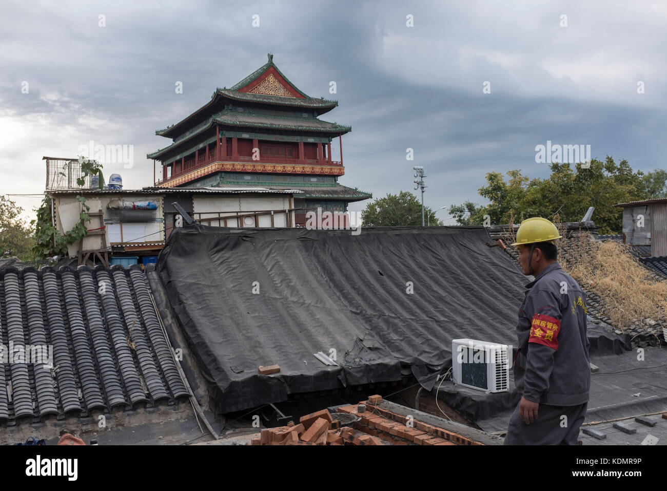 Workers who belong to Housing Authority restore an old house in front of the Drum Tower in Beijing, China. Stock Photo