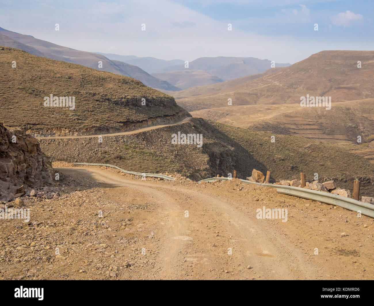 Dangerous and curvy mountain dirt road with steep drop to the valley, Lesotho, Southern Africa Stock Photo
