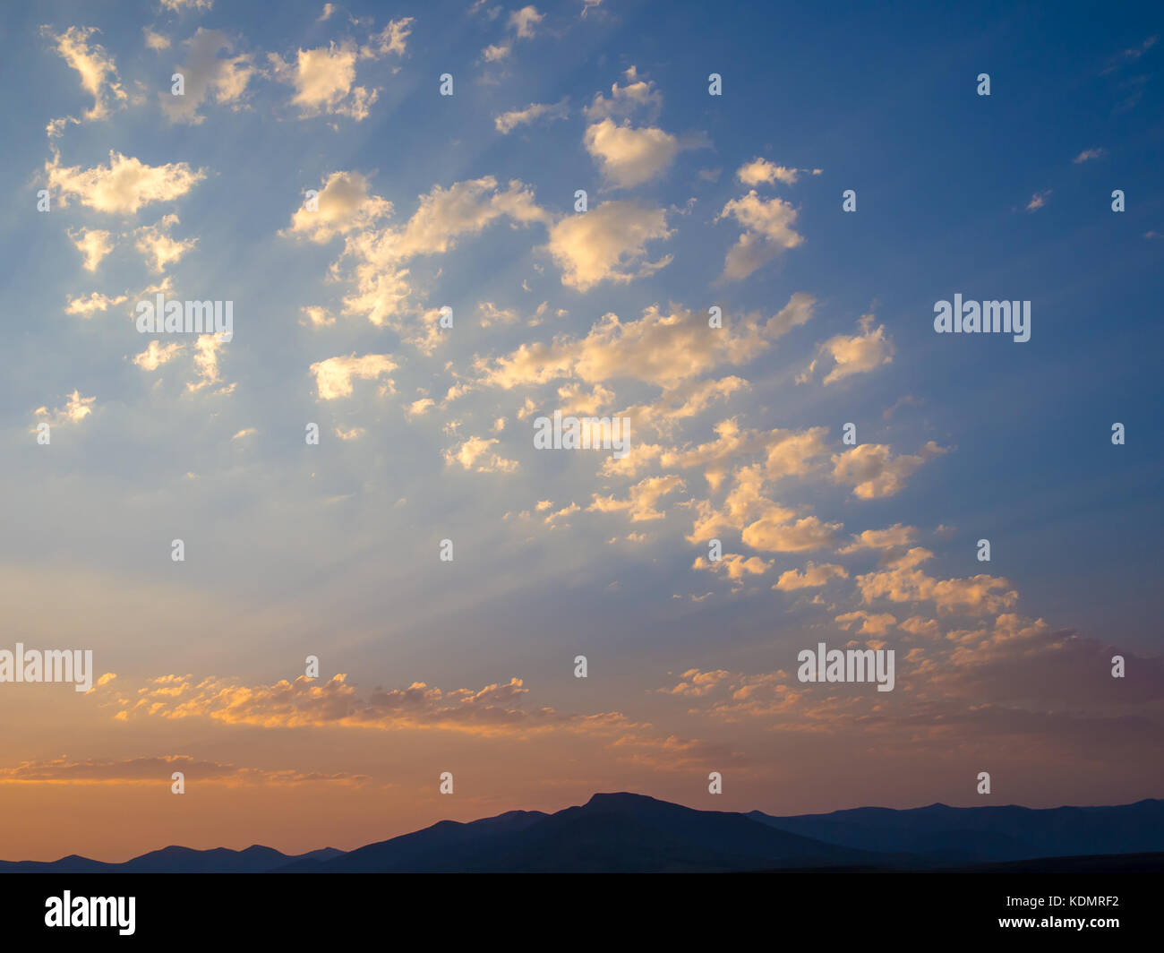 Beautiful mountain landscape with blue orange sky during sunset in the highlands of Lesotho, Southern Africa Stock Photo