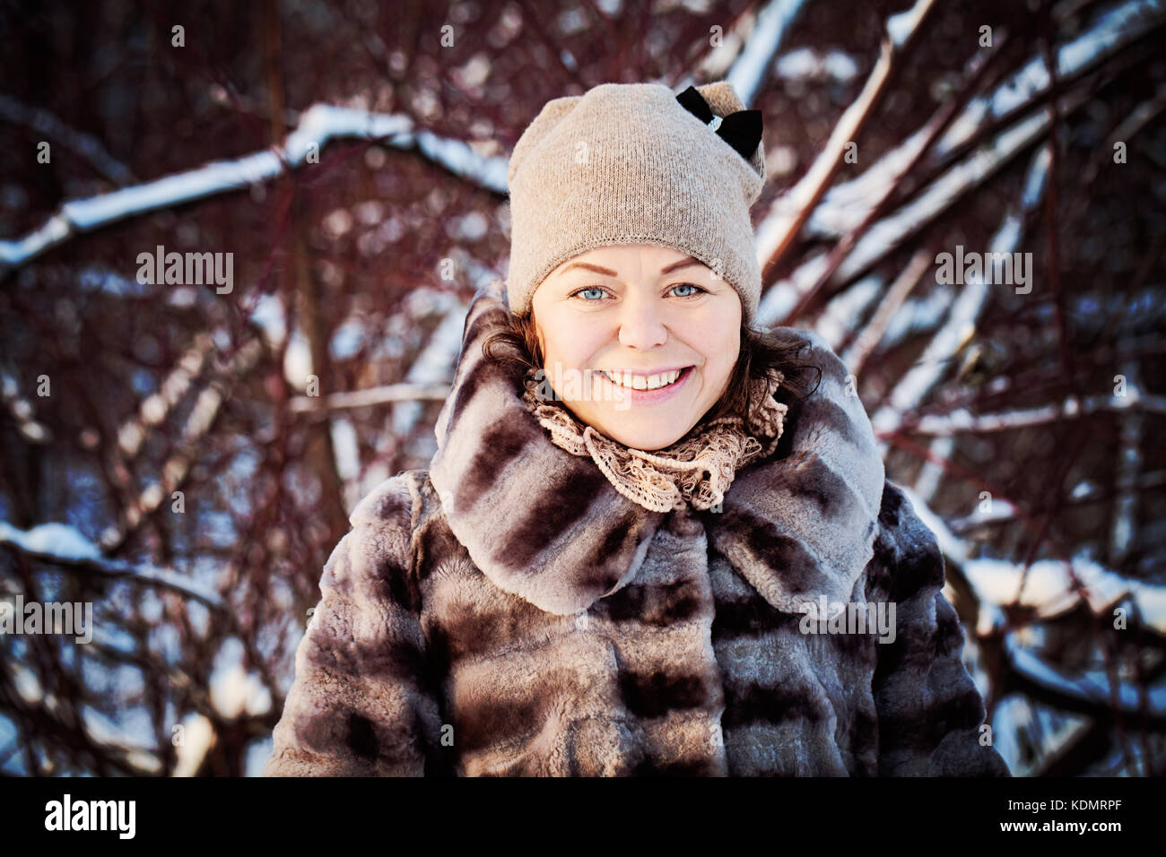 Cute Smiling Woman in Snowy Winter Stock Photo - Alamy