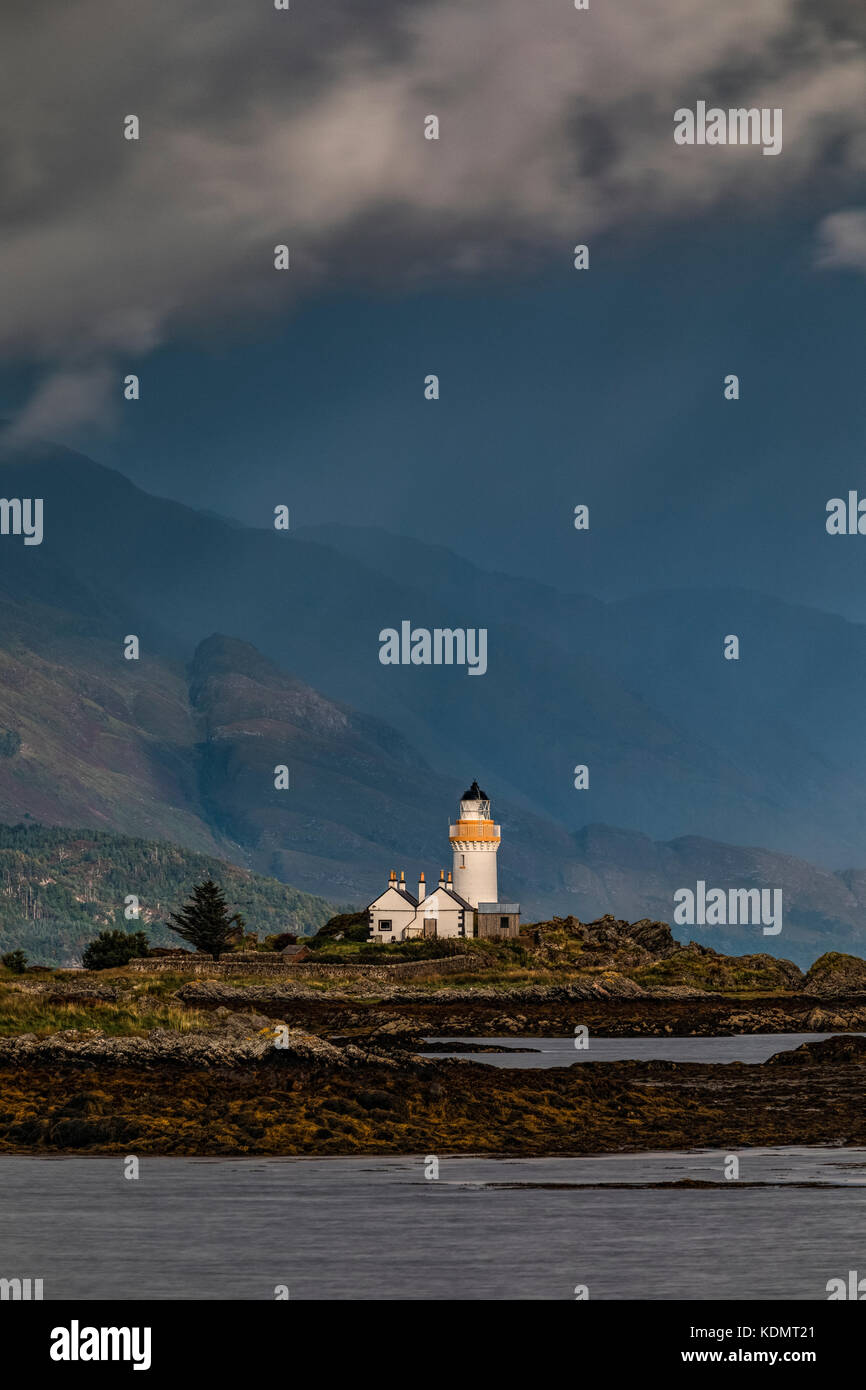 a lighthouse on a tidal islet on a stormy day Stock Photo