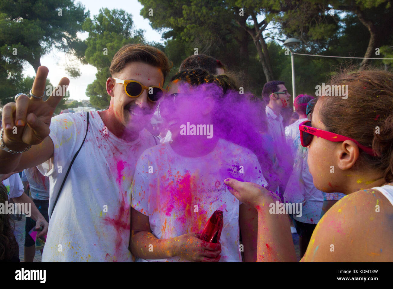 Holi festival of colours, Santa Ponsa, Mallorca Spain. Young covered of coloured powder pigment celebrating the Holi party. Stock Photo