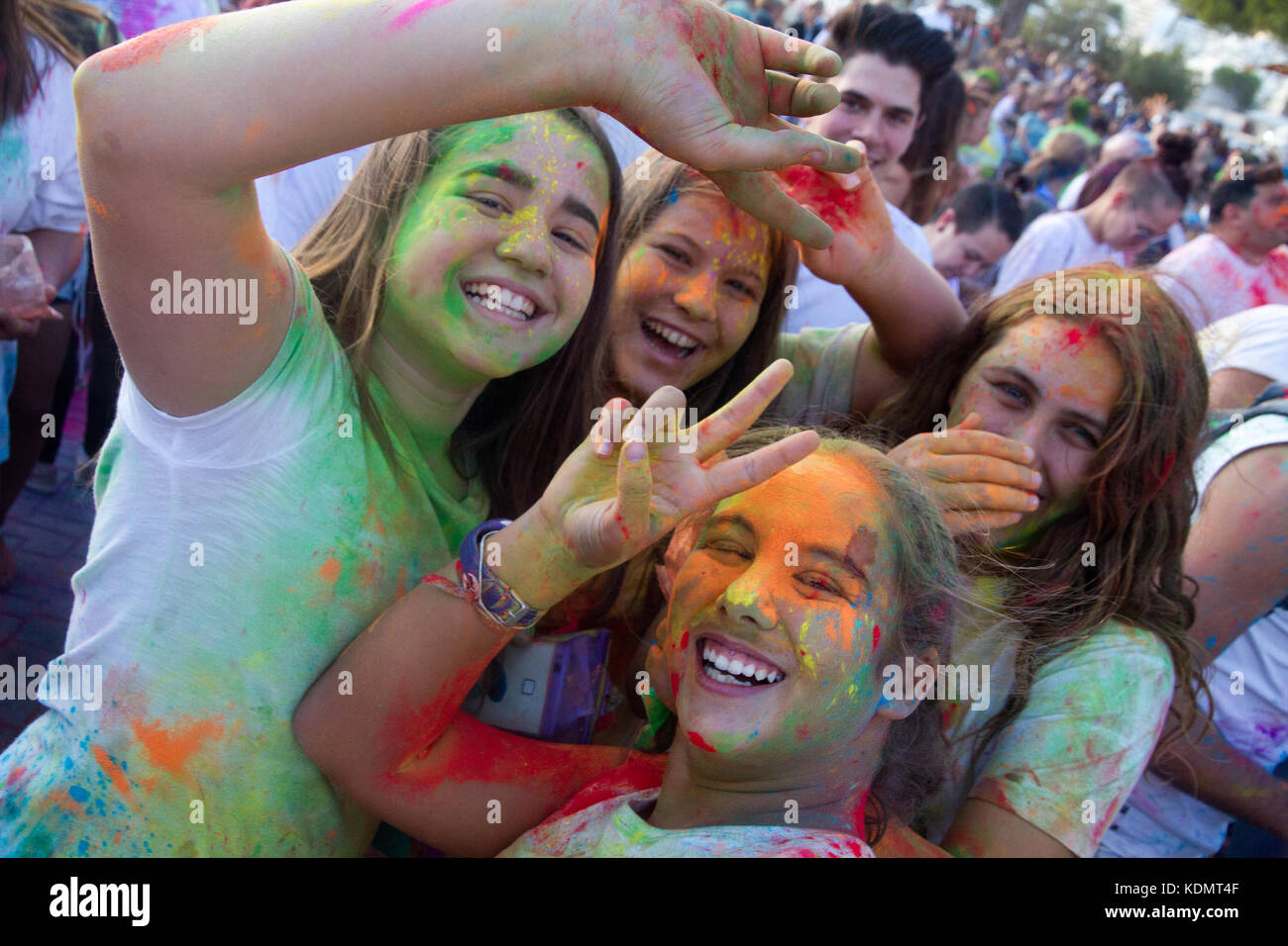 Holi festival of colours, Santa Ponsa, Mallorca Spain. Young girls covered of coloured powder pigment celebrating the Holi party. Stock Photo