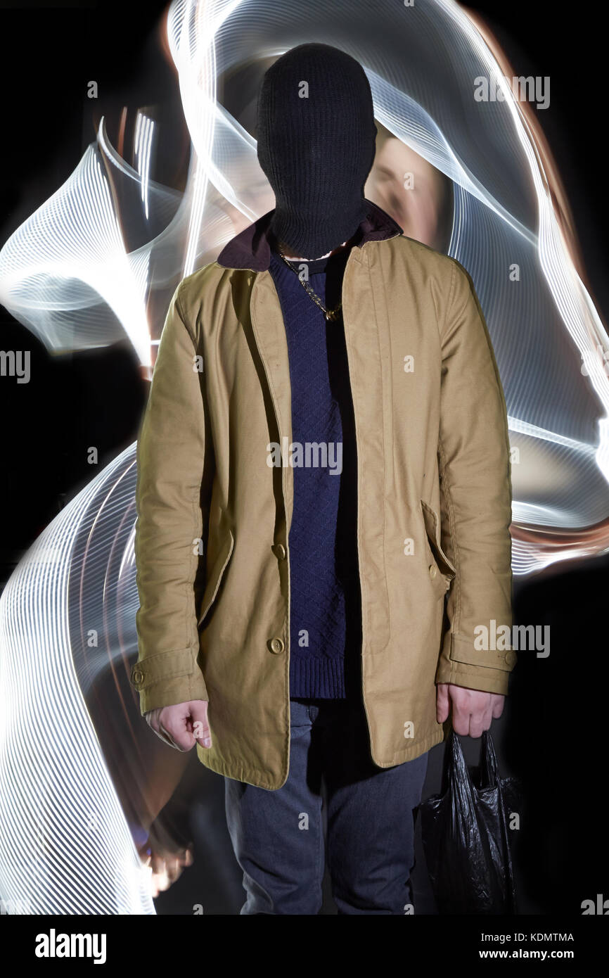 A anonymous man stands while light waves wrap around him Stock Photo