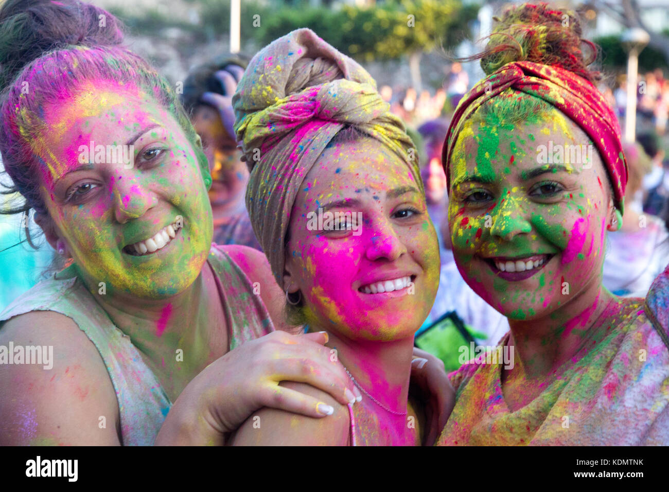 Holi festival of colours, Santa Ponsa, Mallorca Spain. Young covered of coloured powder pigment celebrating the Holi party. Stock Photo