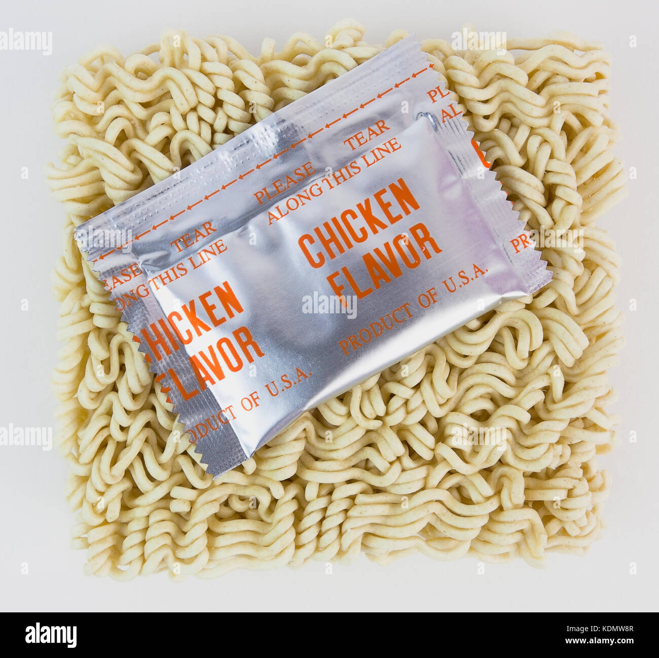 Uncooked ramen noodle meal with chicken flavor packet. Stock Photo